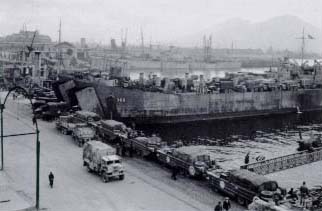 Preloaded supply trucks and DUKWs at Naples.